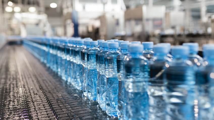 Water bottling line for processing and bottling pure spring water into small blue bottles.
