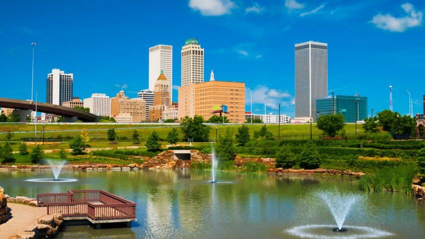 Tulsa skyline with a park, pond, and fountains