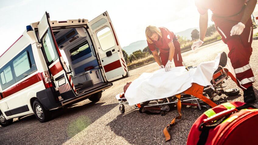 EMT team provide first aid on the street.