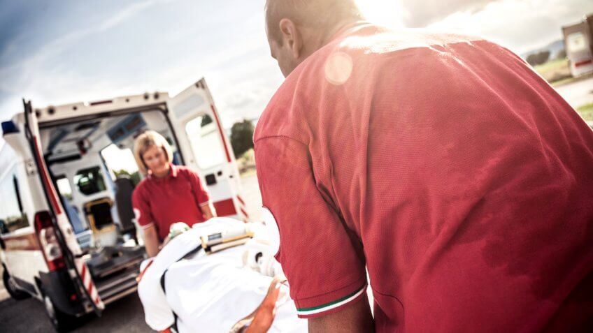 EMT team provide first aid on the street.