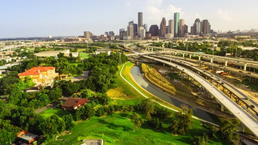 Aerial view downtown and interstate I45 highway with massive int, Texas, USA, road junction overpass and elevated road construction at sunset , stack interchange