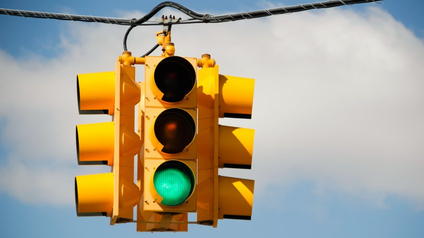 Green light on a traffic signal at an intersection.