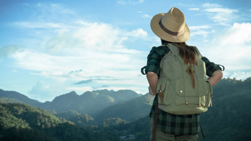 Happy woman tourist to travel in wild trip hiking during vacation.
