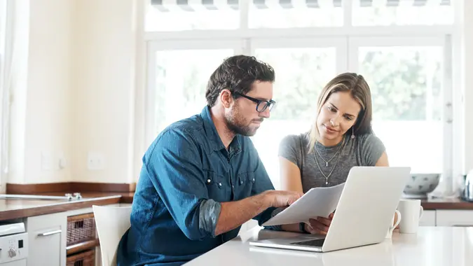 Shot of a young couple working on their finances together at home.