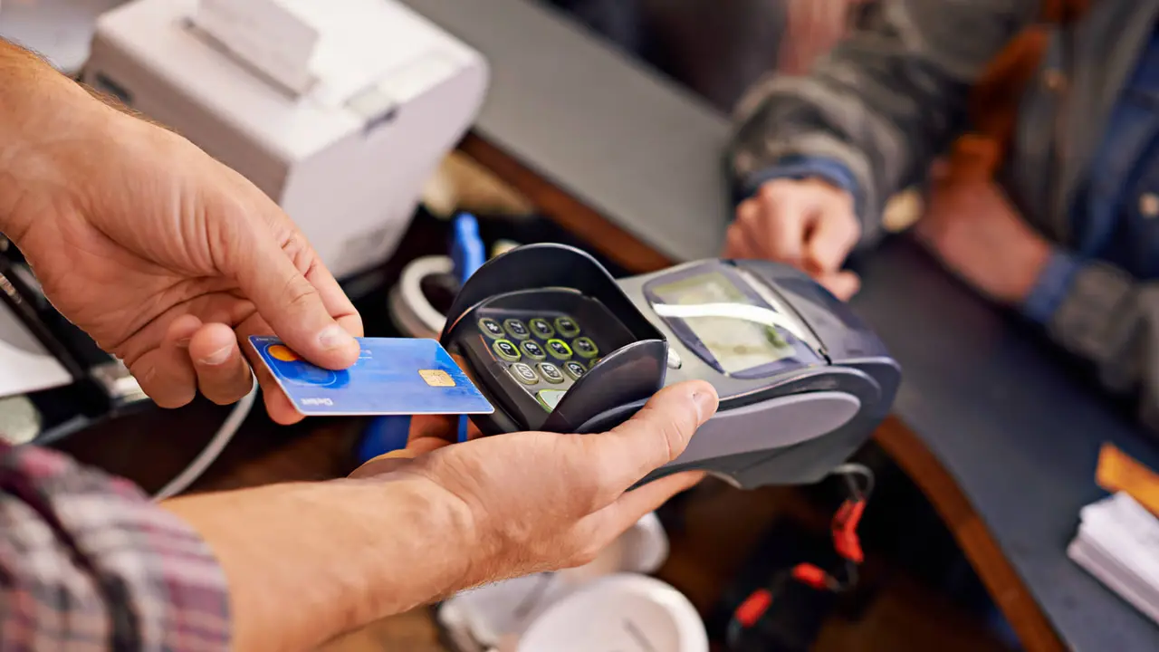 Shot of a customer paying for their order with a debit machine in a cafehttp://195.