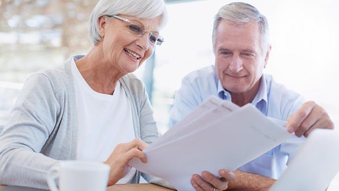 Shot of a senior couple working on their finances using a laptophttp://195.