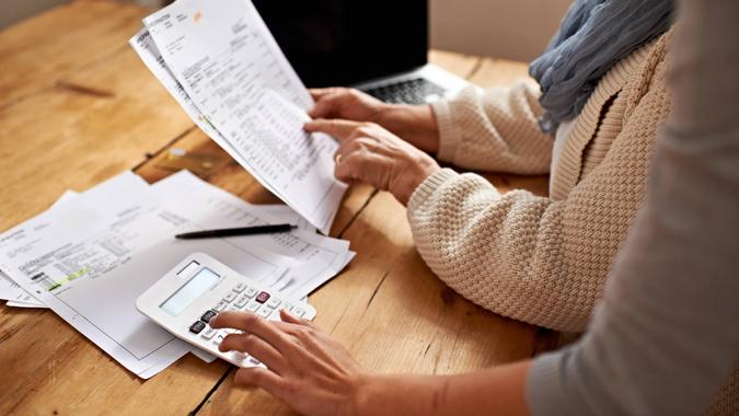 Cropped view of a senior woman receiving help with her finances from her granddaughterhttp://195.