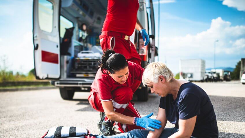 injured woman at the edge of the road.
