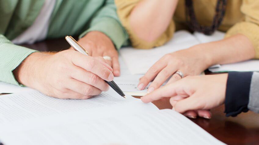 Couple signing contract.