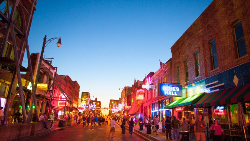 Memphis, TN, USA - June 25, 2017: View of a crowd of tourists enjoying the music clubs and retail establishments that line the famous music district of Beale Street in downtown Memphis, TN at dusk.