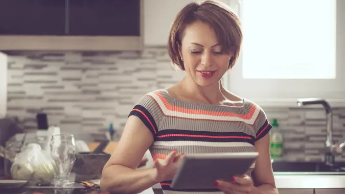 woman doing her banking using a tablet