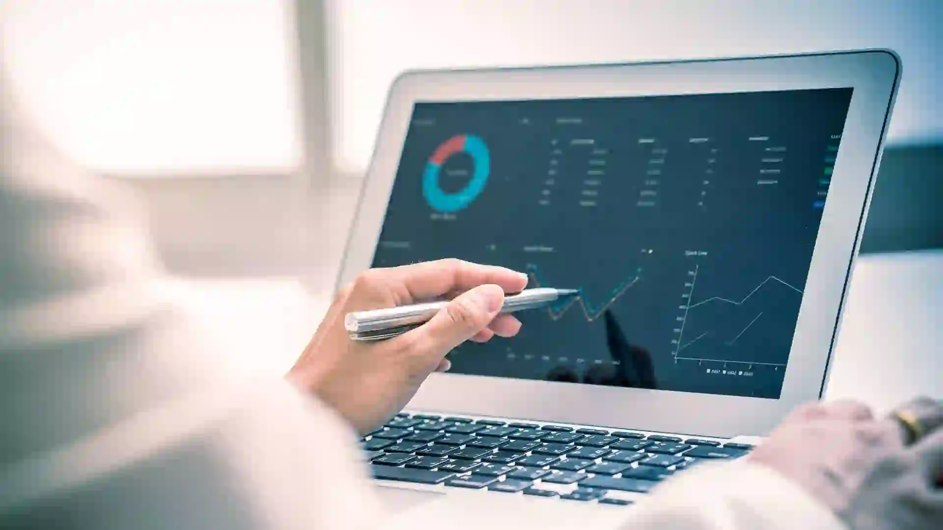 A touchscreen display showing investment growth charts, while someone researches CD laddering.
