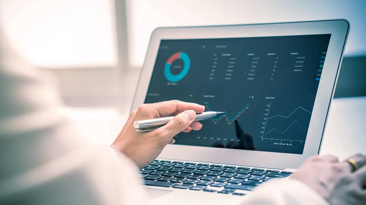 A touchscreen display showing investment growth charts, while someone researches CD laddering.