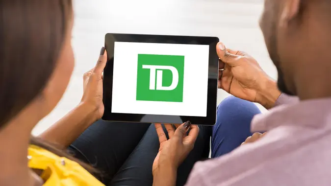 Close-up Of Young African Couple Using Digital Tablet.
