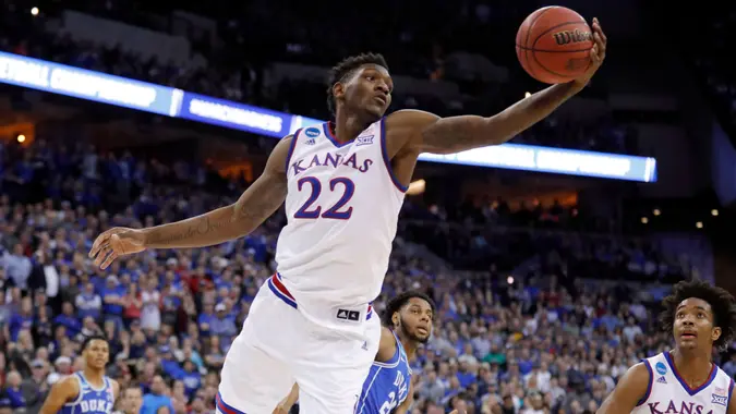 Mandatory Credit: Photo by Charlie Neibergall/AP/REX/Shutterstock (9476199h)Kansas' Silvio De Sousa reaches for a rebound during the first half of a regional final game against Duke in the NCAA men's college basketball tournament, in Omaha, NebNCAA Duke Kansas Basketball, Omaha, USA - 25 Mar 2018.