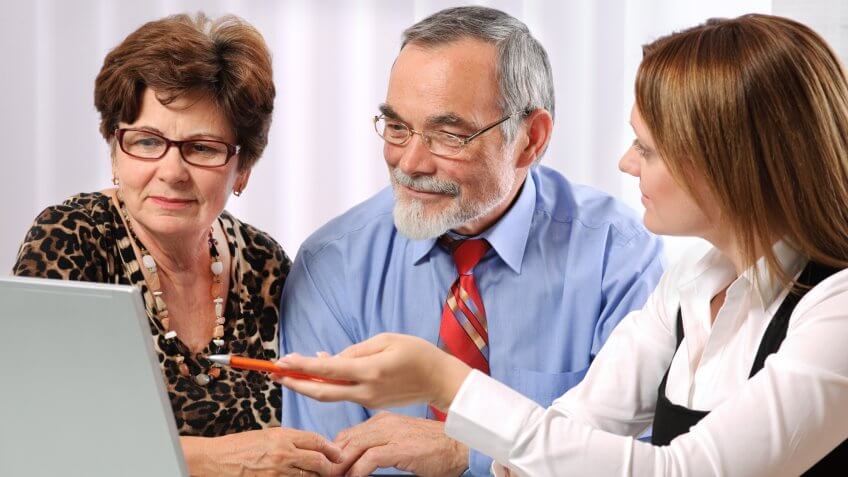 Senior couple meeting with adviser.