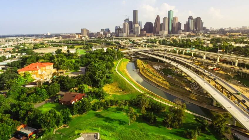 Aerial view downtown and interstate I45 highway with massive int, Texas, USA, road junction overpass and elevated road construction at sunset , stack interchange