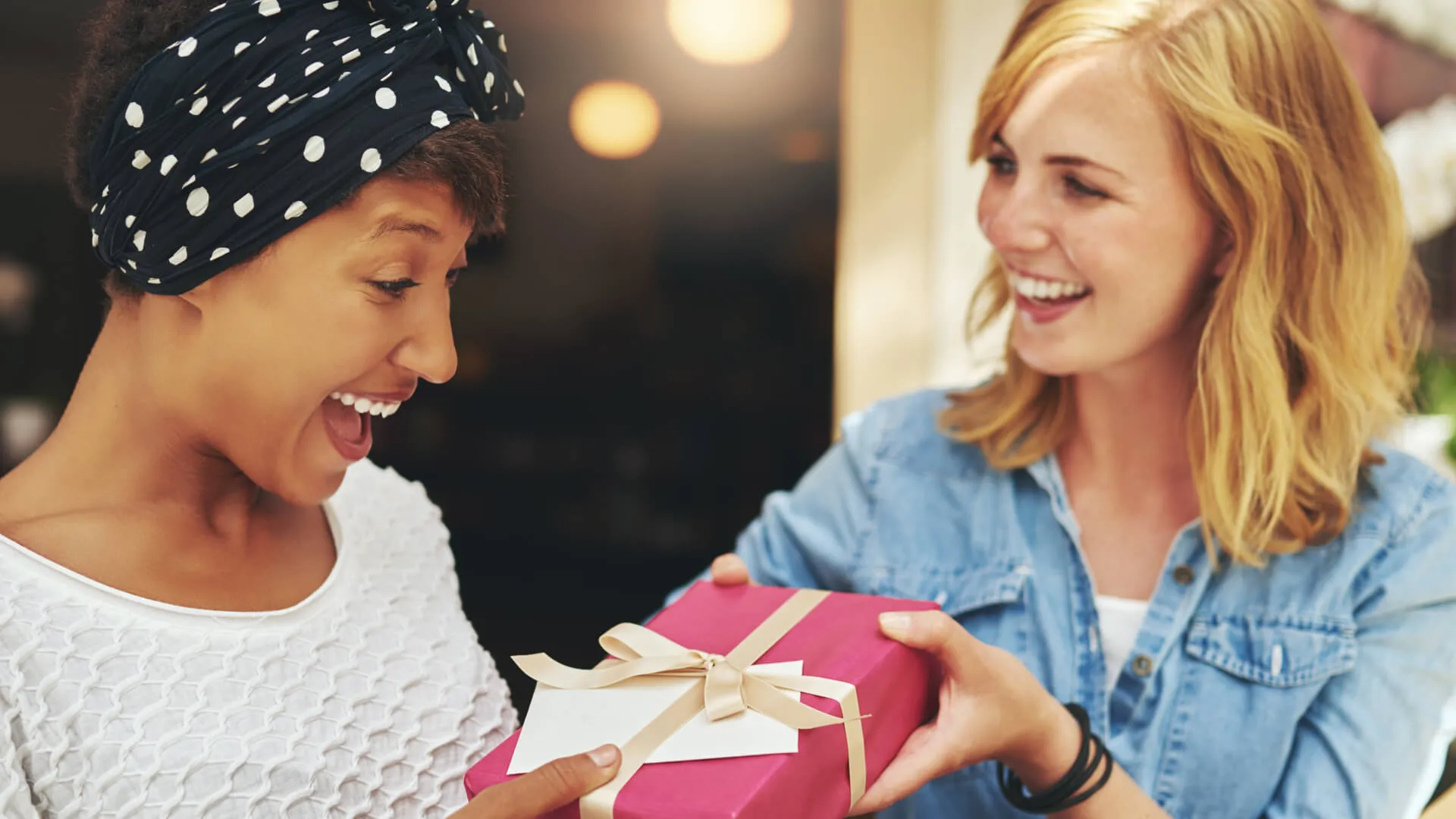 woman giving friend a gift