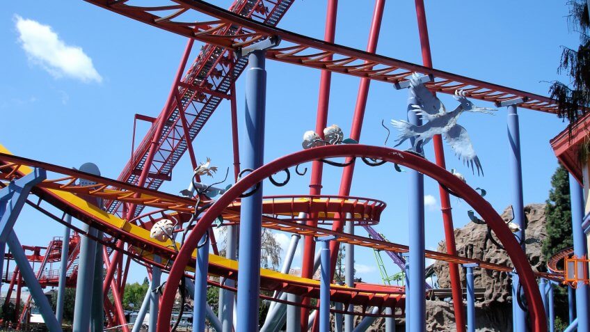 Twisting rails and loops of multiple rides at amusement park.