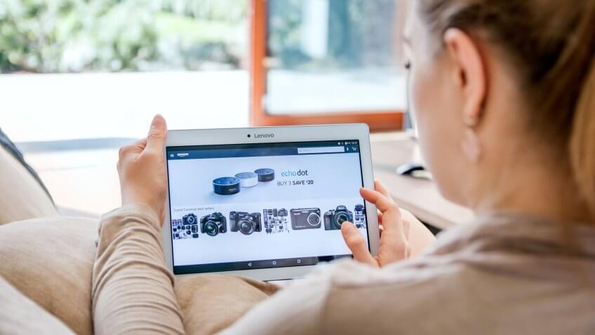 WROCLAW, POLAND- APRIL 10th, 2017: Woman launches amazon application on Lenovo tablet.