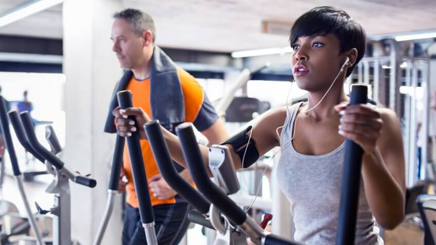 People on the elliptical cross trainer in the gym.
