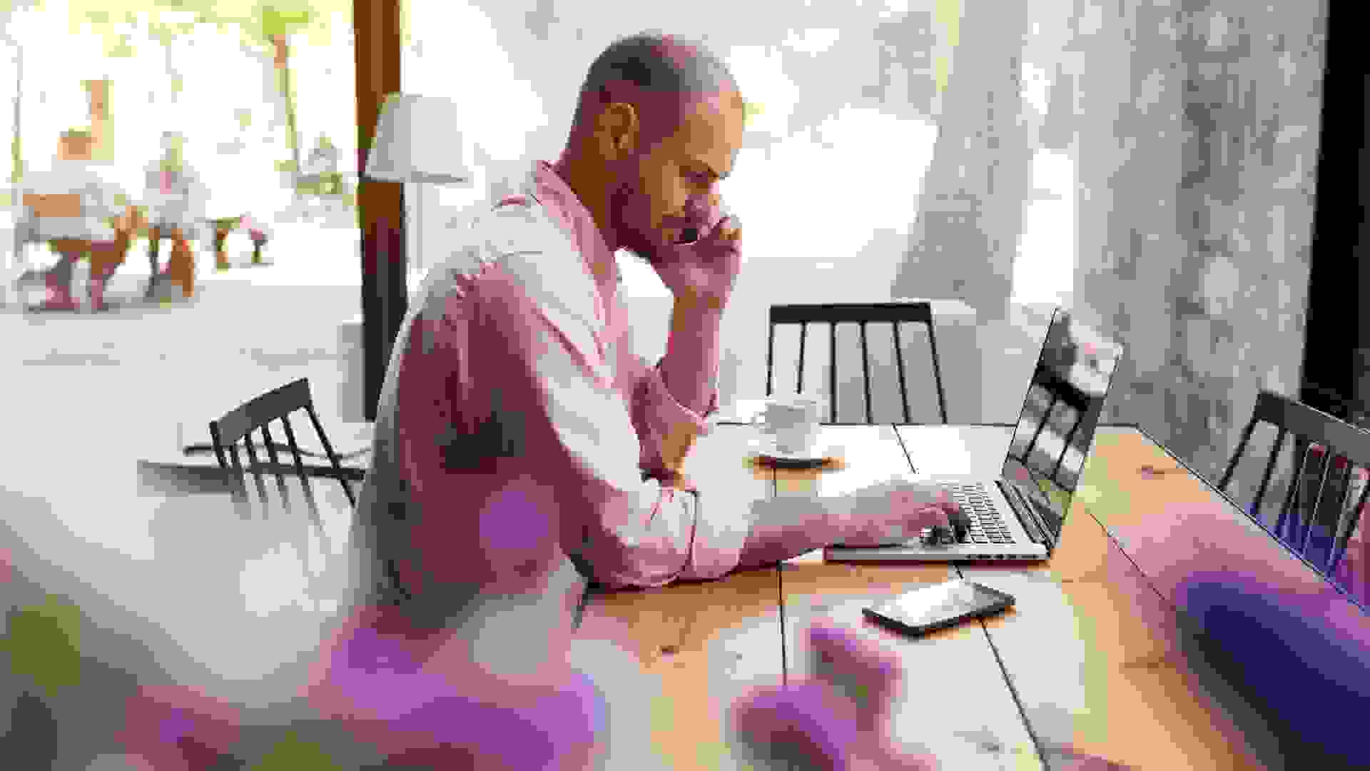 Man working on laptop at cafe