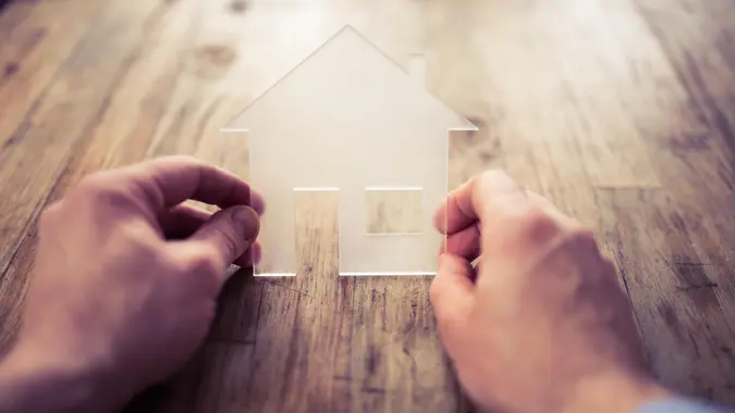 house symbol with hands