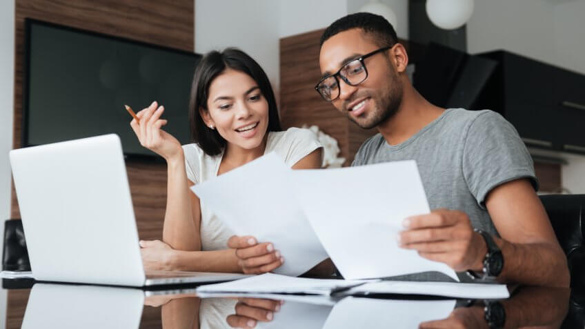 couple using laptop and analyzing their finances