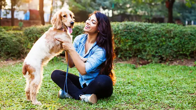 woman-having-fun-with-dog-in-backyard