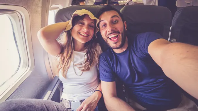 couple taking a selfie on the airplane