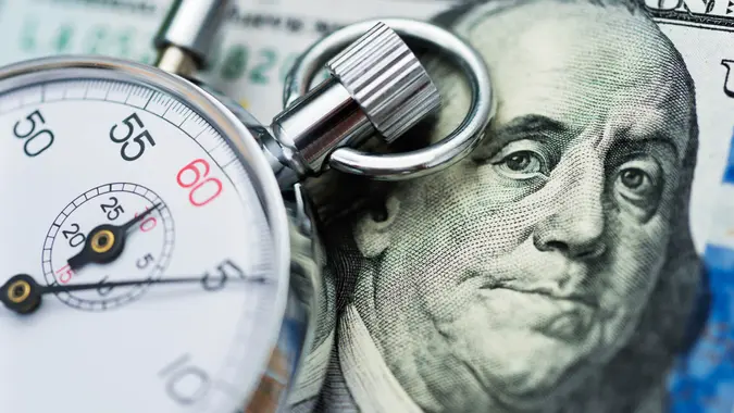 American dollar and stop watch.