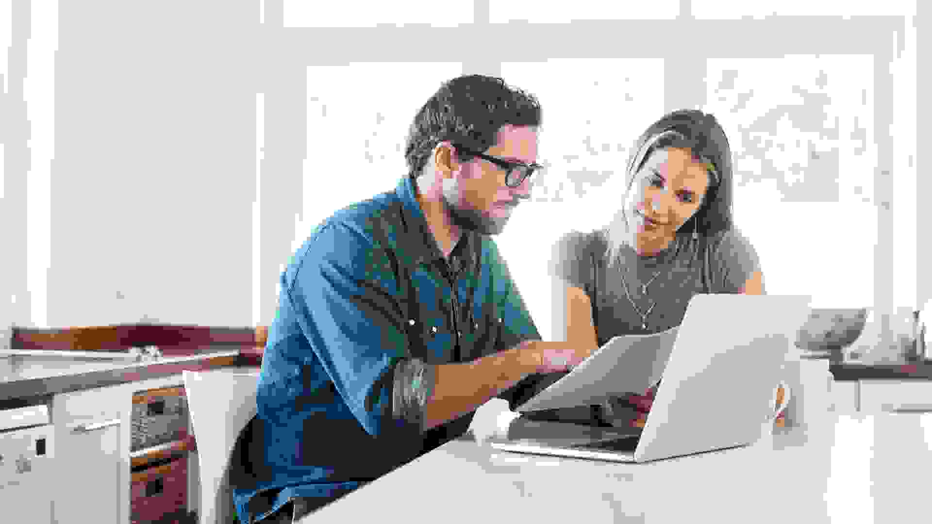 Shot of a young couple working on their finances together at home.