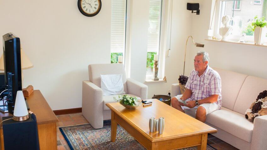 retired man watching television