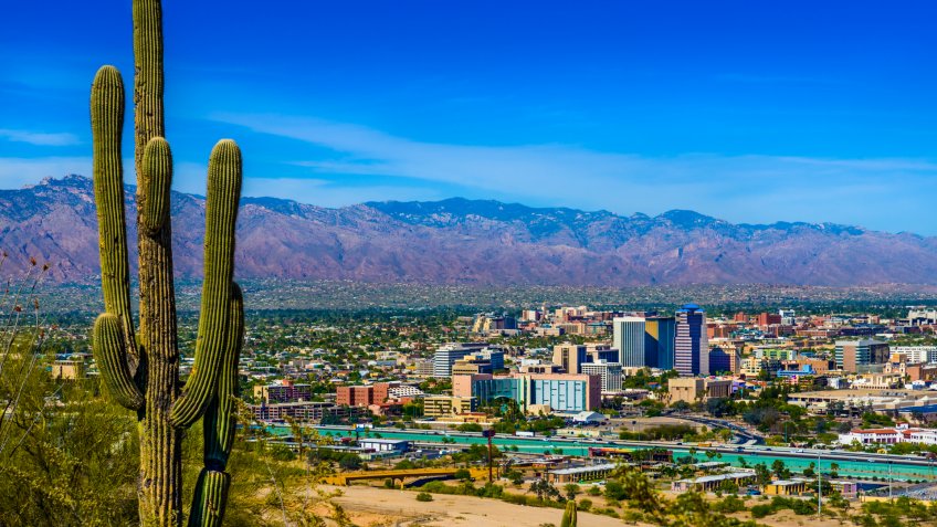 tucson skyline framed by saguaro cactus.