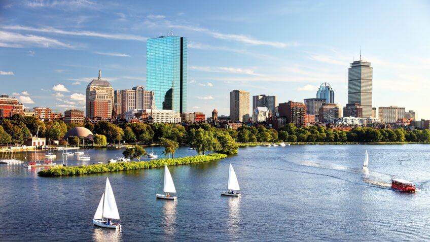 Sailboats on the Charles River with Boston's Back Bay skyline in the background.