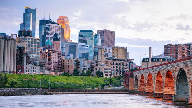 27. Minnesota Downtown Minneapolis, Minnesota at night time as seen from the famous stone arch bridge.