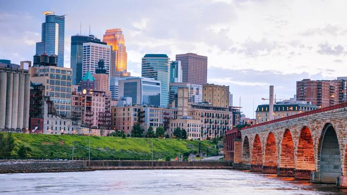 Downtown Minneapolis, Minnesota at night time as seen from the famous stone arch bridge.