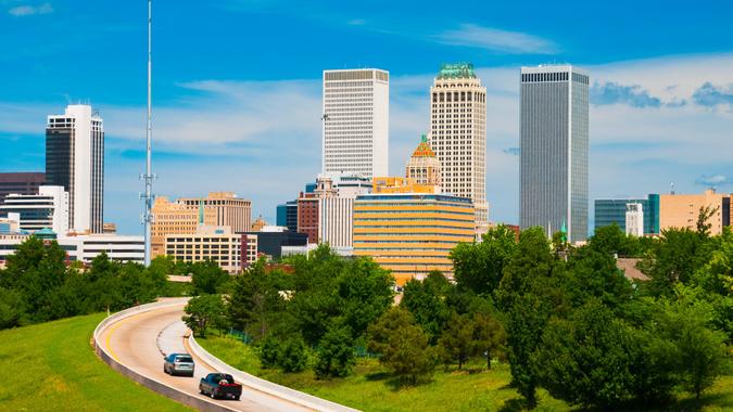 Tulsa downtown skyline and highway interchange / junction ramp with cars.