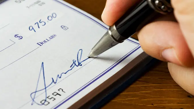 person signing a check