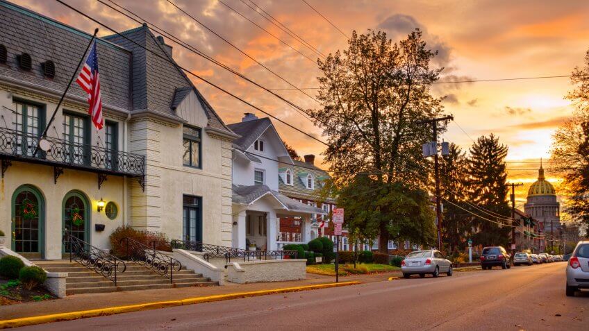 Residential street in downtown Charleston, West Virginia with the Capitol building in the background at sunrise.