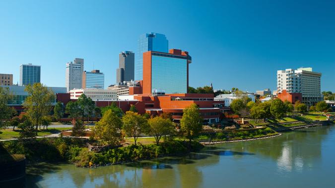 Downtown Little Rock skyline with the Arkansas River in the foreground.