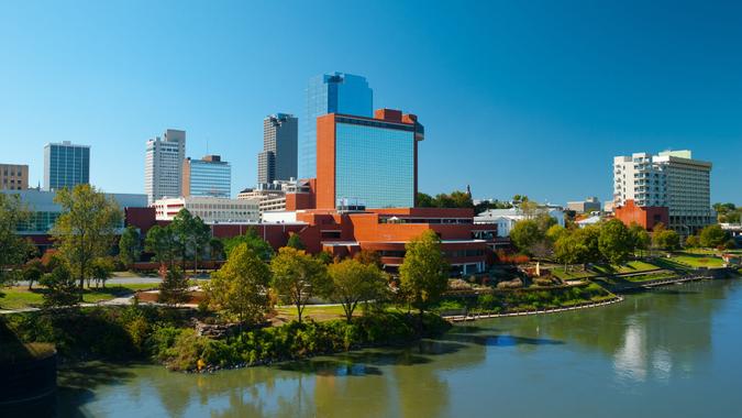 46. Arkansas Downtown Little Rock skyline with the Arkansas River in the foreground.