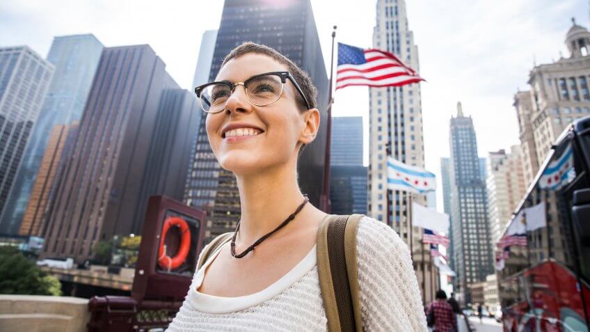 Young woman in downtown Chicago against US flag.