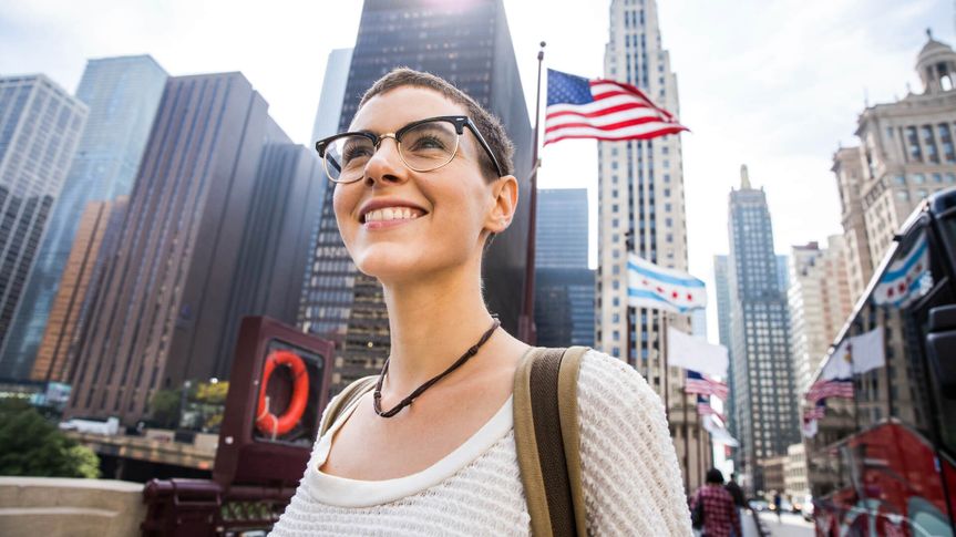 Young woman in downtown Chicago against US flag.