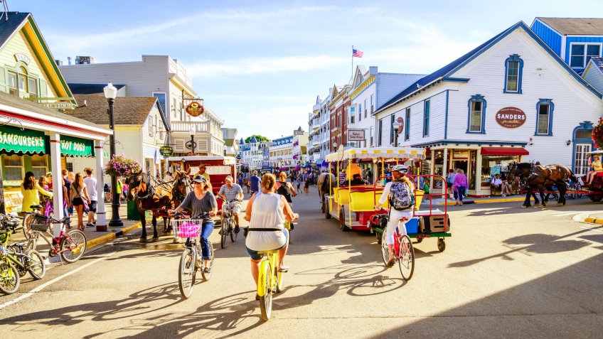 Mackinac Island, Michigan, August 8, 2016: Vacationers take on Market Street on Mackinac Island that is lined with shops and restaurants.