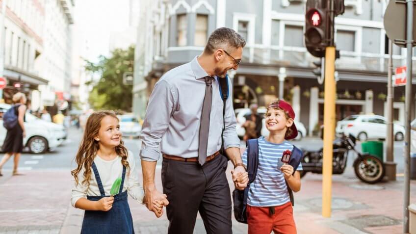 Close up of a father walking his kids home from school.