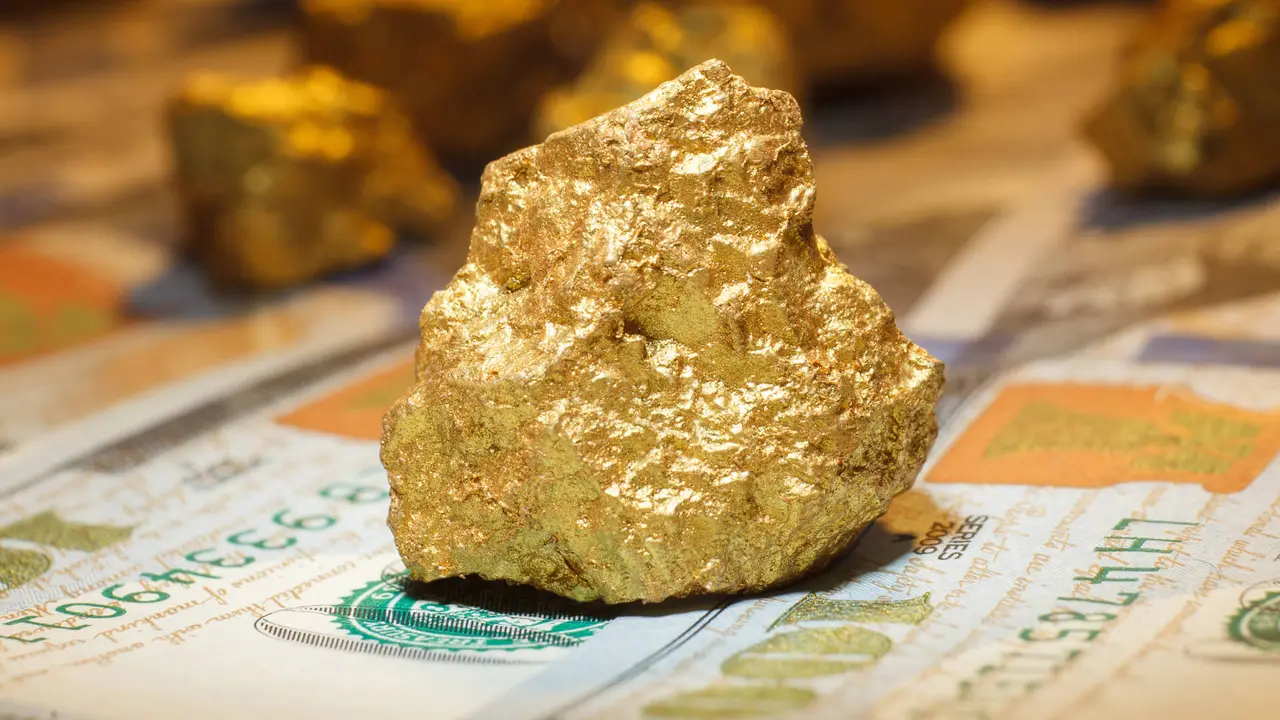 big gold nugget and dollar bills, finance concept.