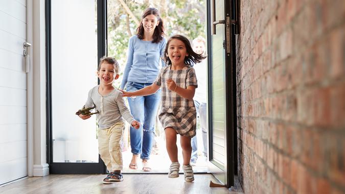 Excited Children Arriving Home With Parents - Image.