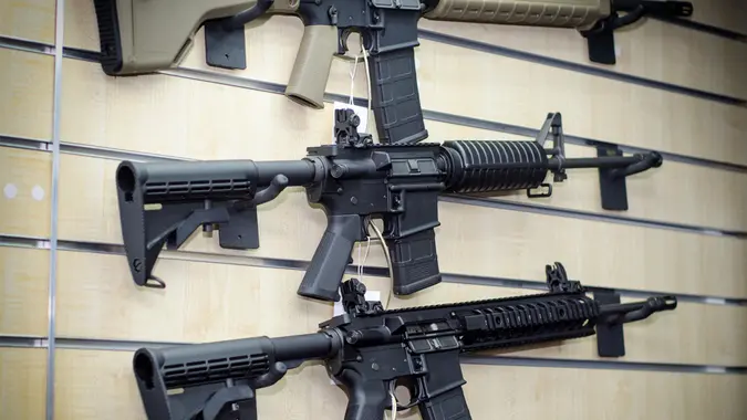 Gun wall rack with rifles.