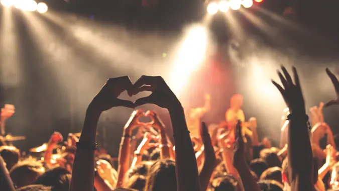 making a heart with your hands at a music festival
